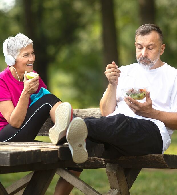 Senior couple taking a break from exercising outdoors